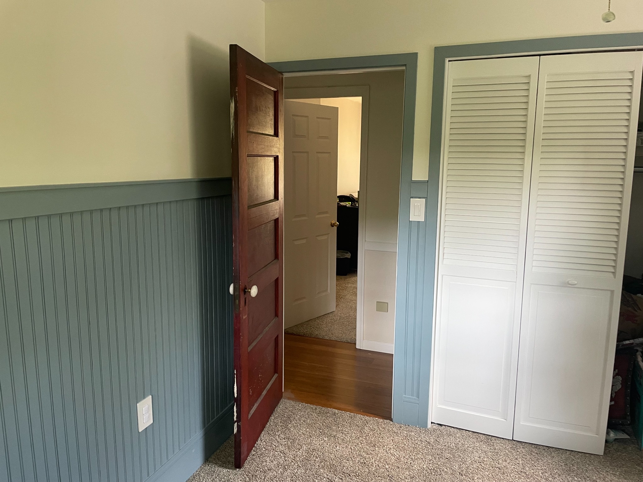Salvaged antique wood door and decorative trim in the completed nursery